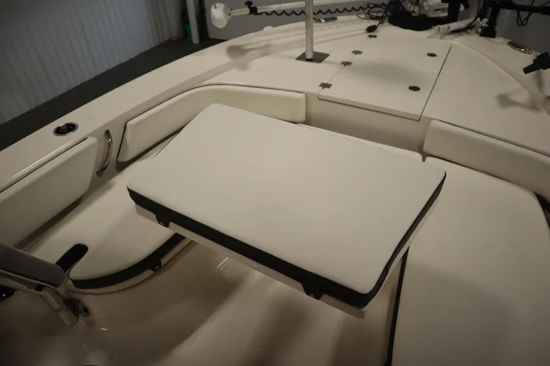 Slide: The Image of 2022 Robalo 246 Cayman boat interior with cushioned seating and storage compartments. - 26