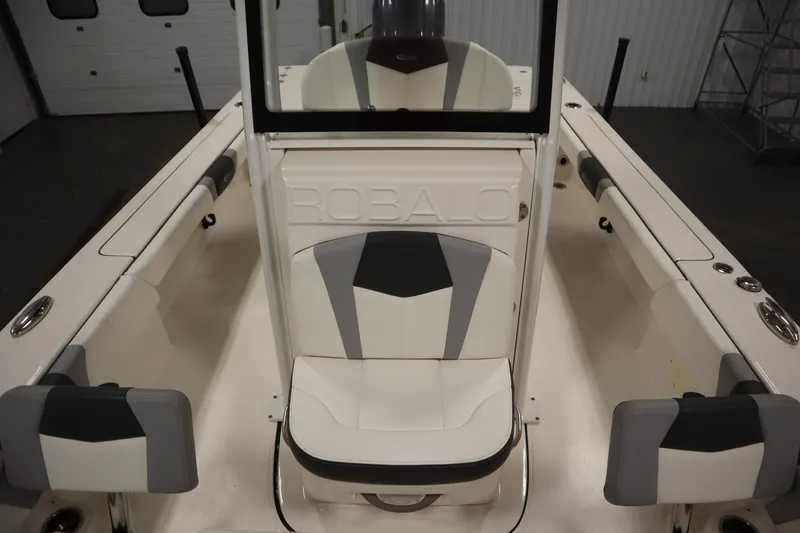 Slide: The Image of 2022 Robalo 246 Cayman boat interior with white and gray seating. - 27
