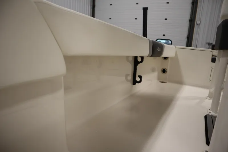 Slide: The Image of 2022 Robalo 246 Cayman boat interior detail, showcasing storage and rod holders. - 31