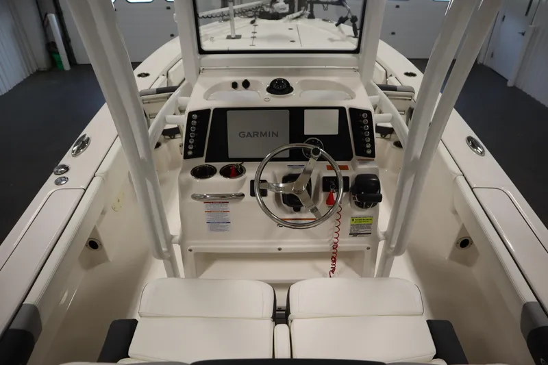 Slide: The Image of 2022 Robalo 246 Cayman boat cockpit with Garmin navigation system and steering wheel. - 34