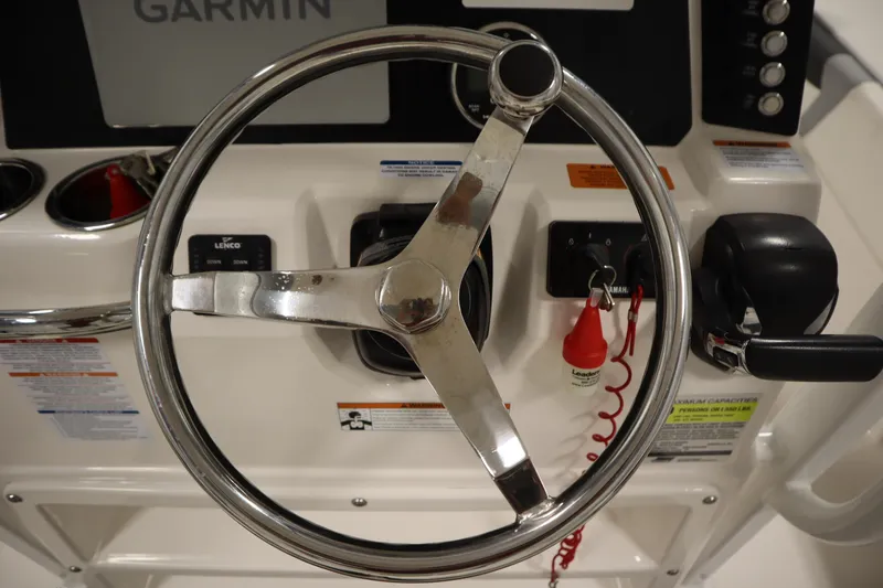 Slide: The Image of Steering wheel and controls of 2022 Robalo 246 Cayman boat with Garmin display. - 35