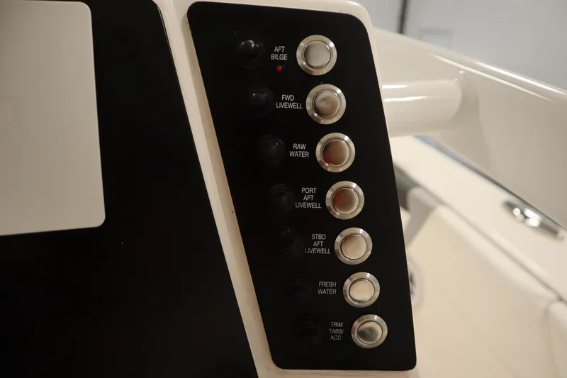 Slide: The Image of Control panel of 2022 Robalo 246 Cayman boat with various function buttons. - 38