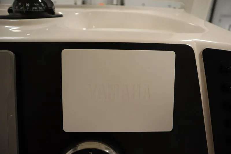 Slide: The Image of 2022 Robalo 246 Cayman boat dashboard featuring Yamaha controls. - 41