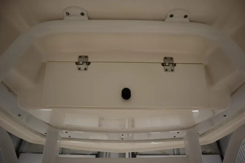 Slide: The Image of 2022 Robalo 246 Cayman storage compartment with secure latch and sleek design. - 48
