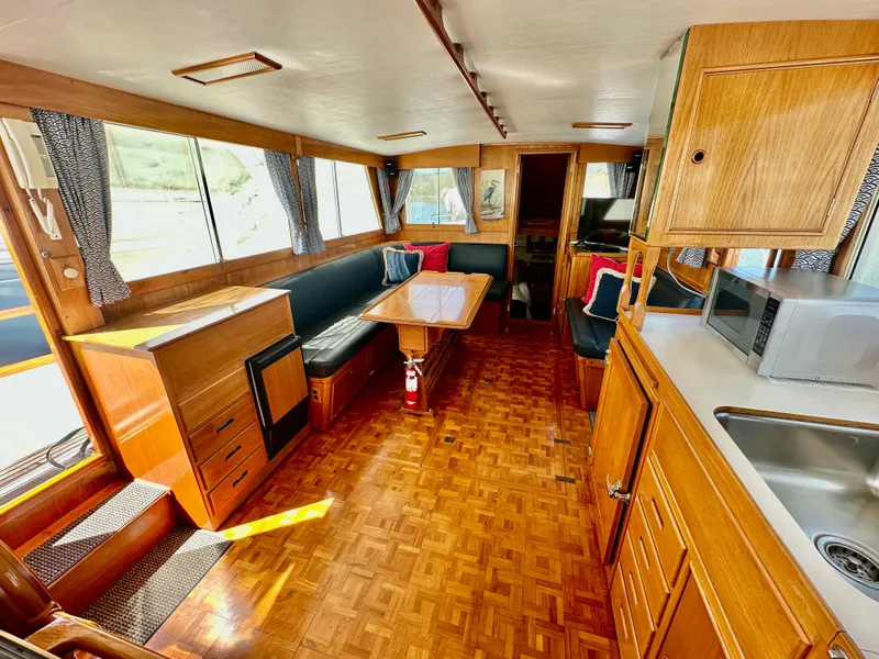 Slide: The Image of Interior of 1989 Grand Banks 42 Classic yacht with wood finish and seating area. - 17