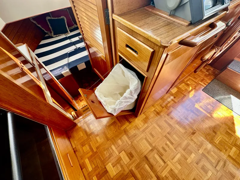 Slide: The Image of Interior of 1989 Grand Banks 42 Classic yacht with wood finish and striped bedding. - 22