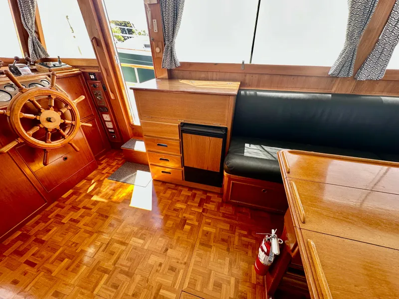 Slide: The Image of Interior of 1989 Grand Banks 42 Classic yacht with wooden helm and seating area. - 23