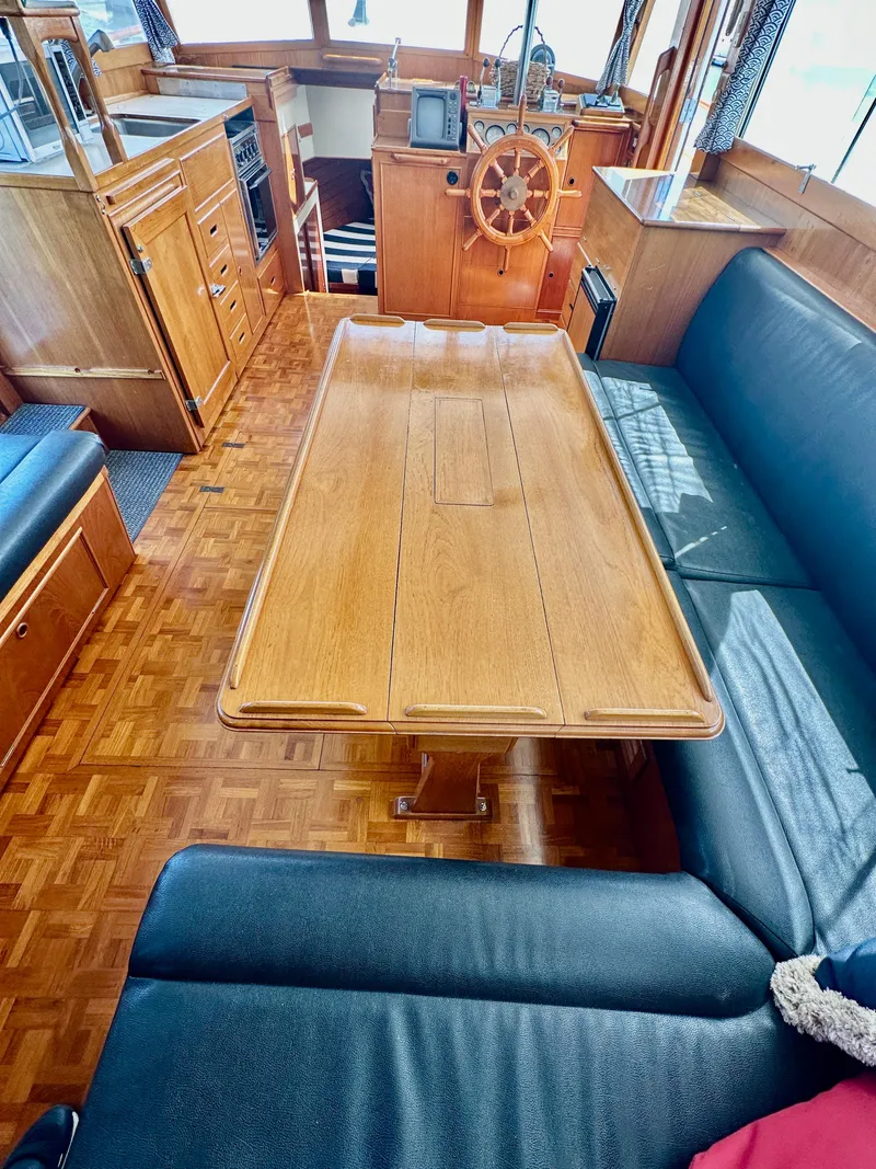 Slide: The Image of Interior of 1989 Grand Banks 42 Classic yacht with wooden table and seating area. - 27