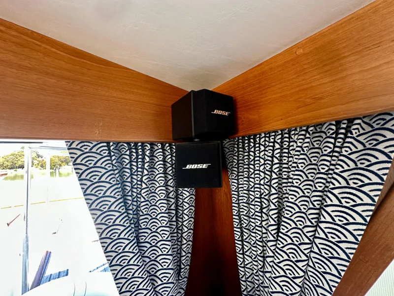 Slide: The Image of Bose speakers on a 1989 Grand Banks 42 Classic with patterned curtains. - 31