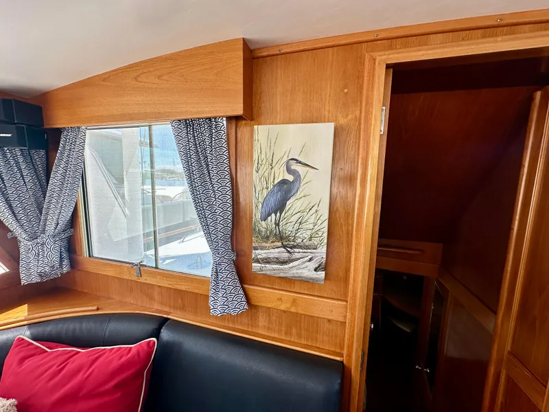 Slide: The Image of Interior of 1989 Grand Banks 42 Classic with heron painting and patterned curtains. - 34