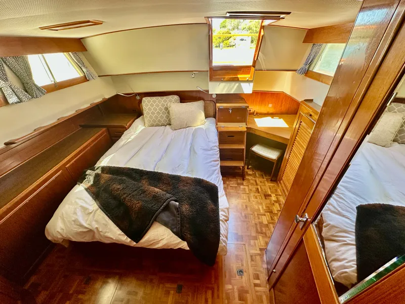 Slide: The Image of Cozy bedroom in 1989 Grand Banks 42 Classic yacht with wood accents and natural light. - 37