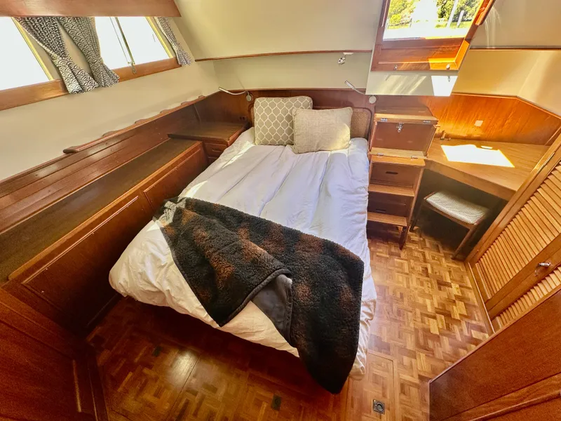 Slide: The Image of Cozy bedroom in 1989 Grand Banks 42 Classic yacht with wood accents and natural light. - 38