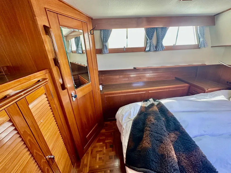 Slide: The Image of Cozy cabin interior of 1989 Grand Banks 42 Classic with wood paneling and bed. - 39