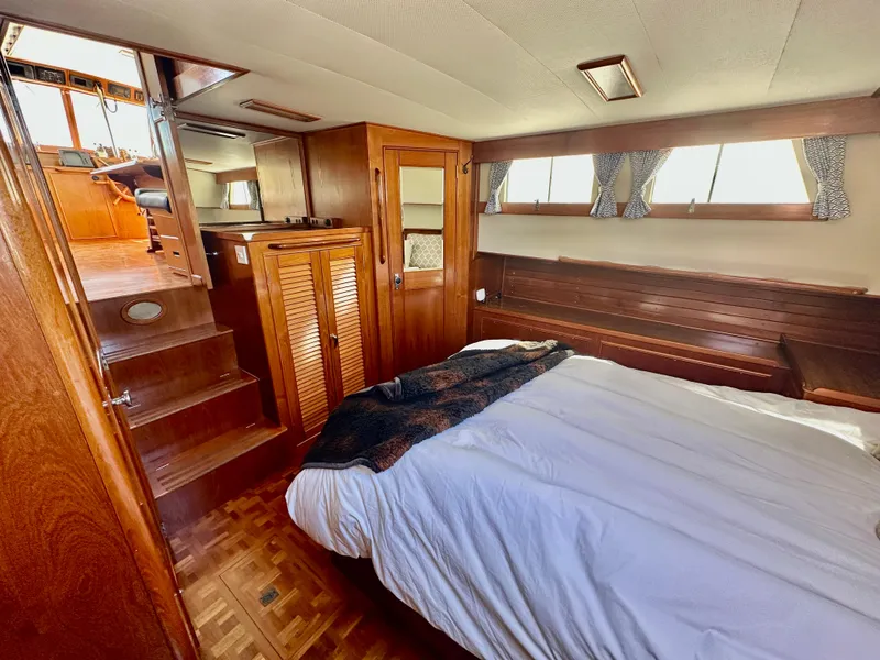Slide: The Image of 1989 Grand Banks 42 Classic yacht interior with wooden furnishings and cozy bedroom. - 42