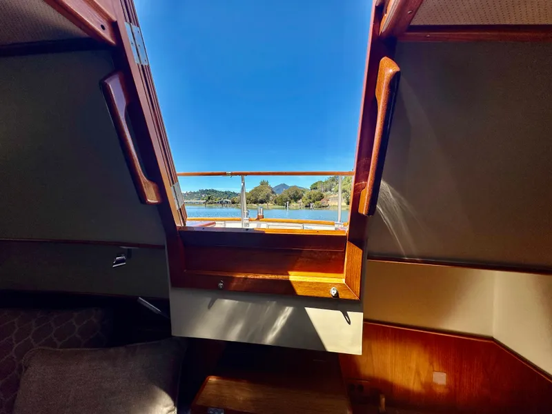 Slide: The Image of Interior view from a 1989 Grand Banks 42 Classic yacht, showcasing a scenic waterway. - 44