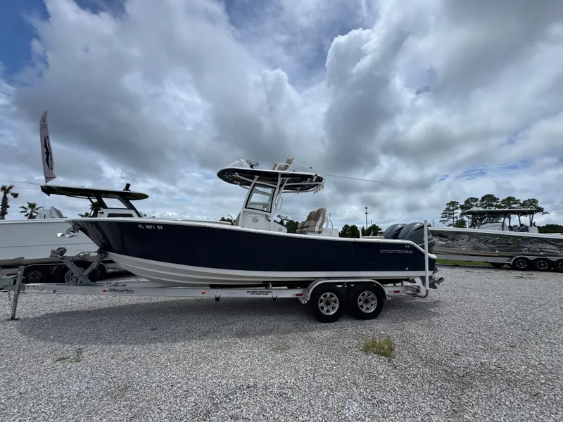 Slide: The Image of 2020 Sportsman Open 282TE Center Console boat on trailer under cloudy sky. - 10