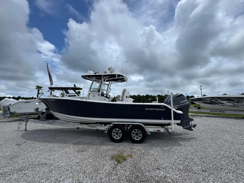 Slide: The Image of 2020 Sportsman Open 282TE Center Console boat on trailer under cloudy sky. - 11