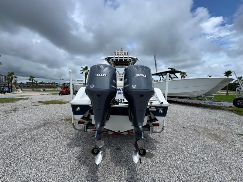 Slide: The Image of 2020 Sportsman Open 282TE Center Console with dual Yamaha 300 engines, parked outdoors. - 14