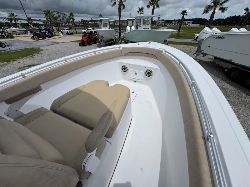 Slide: The Image of 2020 Sportsman Open 282TE Center Console boat interior with beige seating and speakers. - 18
