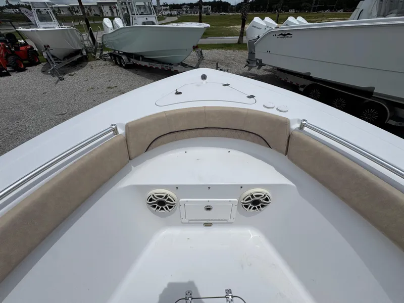 Slide: The Image of 2020 Sportsman Open 282TE Center Console boat interior with cushioned seating and speakers. - 19
