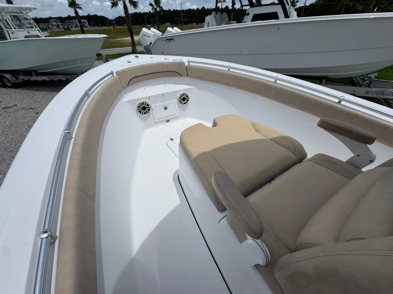 Slide: The Image of 2020 Sportsman Open 282TE Center Console boat interior with beige seating and speakers. - 20