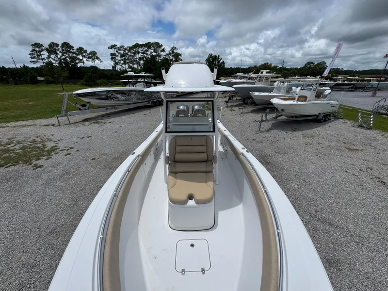 Slide: The Image of 2020 Sportsman Open 282TE Center Console boat displayed outdoors with other boats. - 22