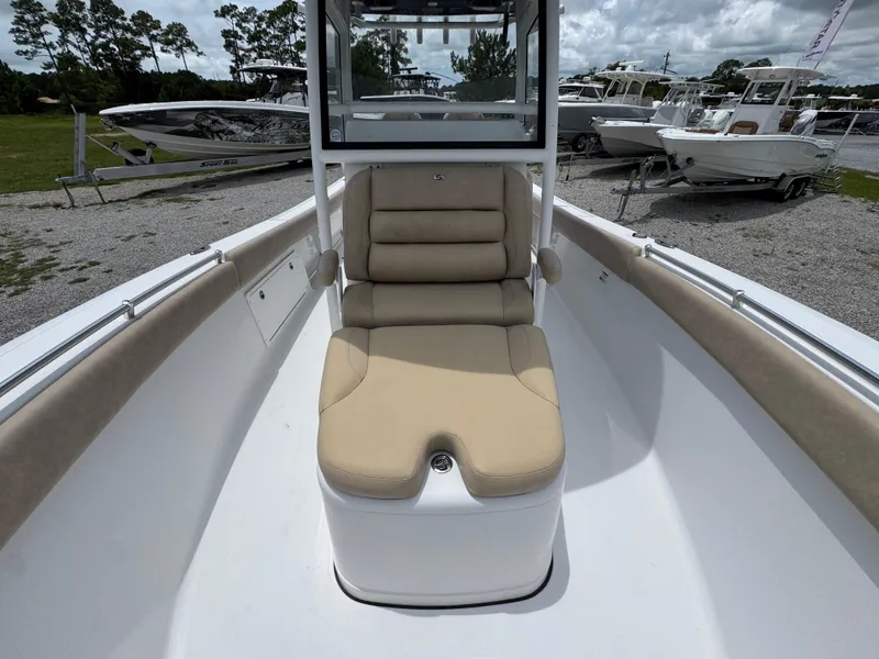 Slide: The Image of 2020 Sportsman Open 282TE Center Console boat with beige seating, parked outdoors. - 24