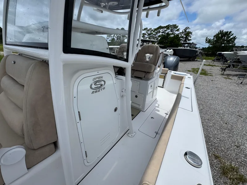 Slide: The Image of 2020 Sportsman Open 282TE Center Console boat on gravel lot, featuring seating and console. - 25