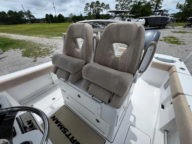 Slide: The Image of 2020 Sportsman Open 282TE Center Console boat with dual cushioned seats and steering wheel. - 27
