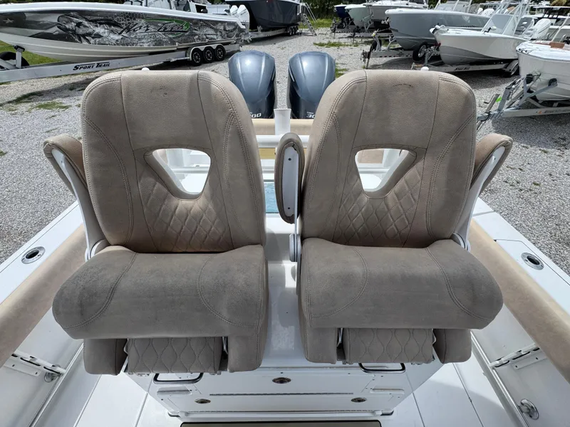 Slide: The Image of 2020 Sportsman Open 282TE Center Console boat seats, featuring plush, diamond-stitched upholstery. - 28