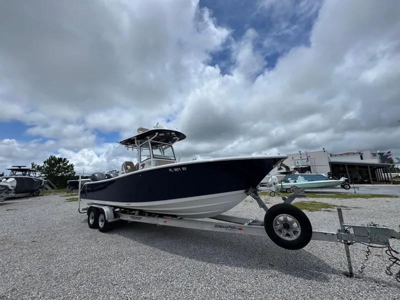Slide: The Image of 2020 Sportsman Open 282TE Center Console boat on trailer under cloudy sky. - 3