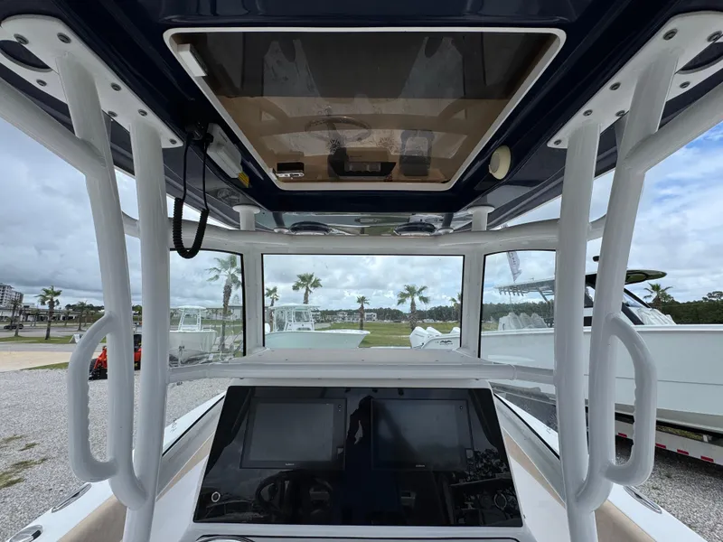 Slide: The Image of 2020 Sportsman Open 282TE Center Console boat interior with navigation screens and T-top. - 31