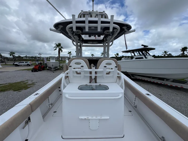 Slide: The Image of 2020 Sportsman Open 282TE Center Console boat with seating and storage, parked outdoors. - 39
