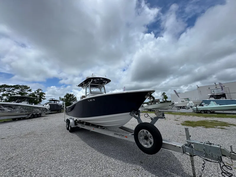 Slide: The Image of 2020 Sportsman Open 282TE Center Console boat on trailer under cloudy sky. - 4
