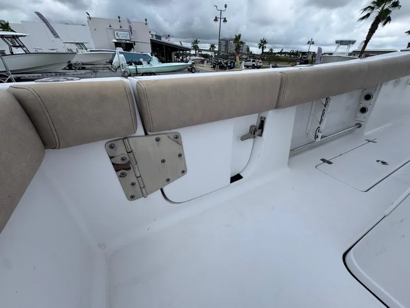 Slide: The Image of 2020 Sportsman Open 282TE Center Console boat interior with cushioned seating and storage compartments. - 40