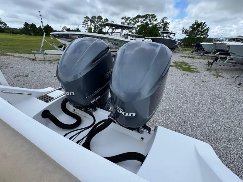 Slide: The Image of 2020 Sportsman Open 282TE Center Console with dual Yamaha 300 engines in a boatyard. - 43