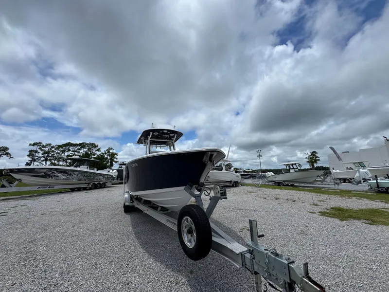 Slide: The Image of 2020 Sportsman Open 282TE Center Console boat on trailer under cloudy sky. - 5