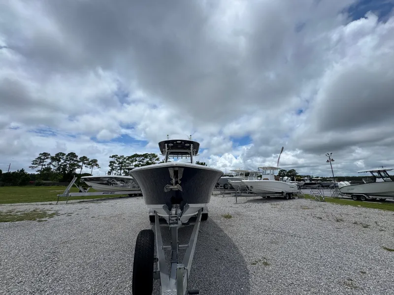 Slide: The Image of 2020 Sportsman Open 282TE Center Console boat on trailer under cloudy sky. - 6