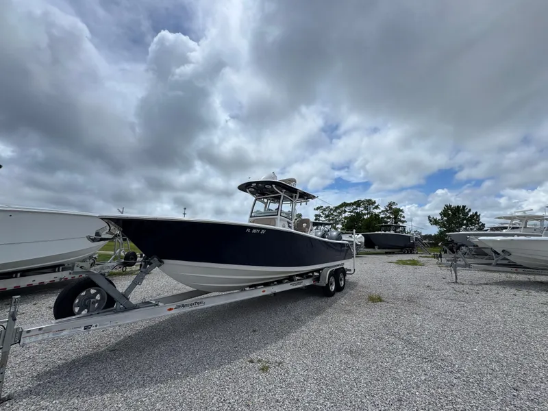 Slide: The Image of 2020 Sportsman Open 282TE Center Console boat on trailer under cloudy sky. - 8