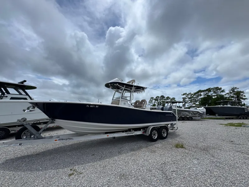 Slide: The Image of 2020 Sportsman Open 282TE Center Console boat on trailer under cloudy sky. - 9