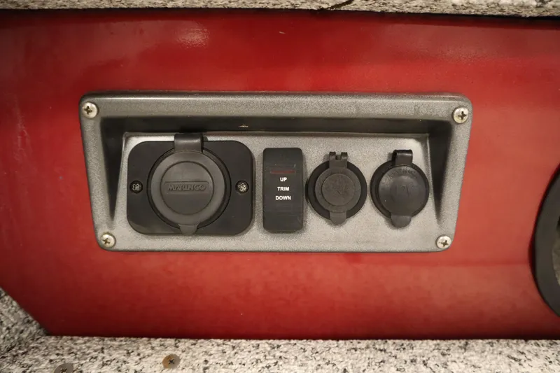 Slide: The Image of Control panel on a 2023 Polar Kraft 2010 OUTLANDER DC boat, featuring switches and outlets. - 12