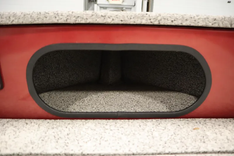 Slide: The Image of Storage compartment in 2023 Polar Kraft 2010 OUTLANDER DC boat, featuring red exterior and gray interior. - 13