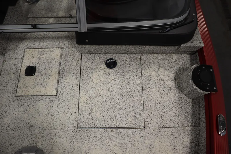 Slide: The Image of Interior view of 2023 Polar Kraft 2010 OUTLANDER DC boat, featuring speckled flooring and storage compartments. - 16