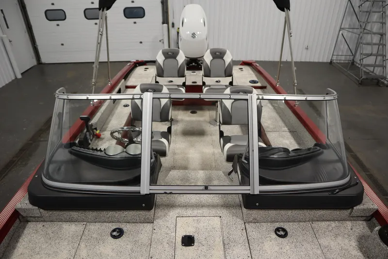 Slide: The Image of 2023 Polar Kraft 2010 Outlander DC boat interior with seating and steering wheel. - 22