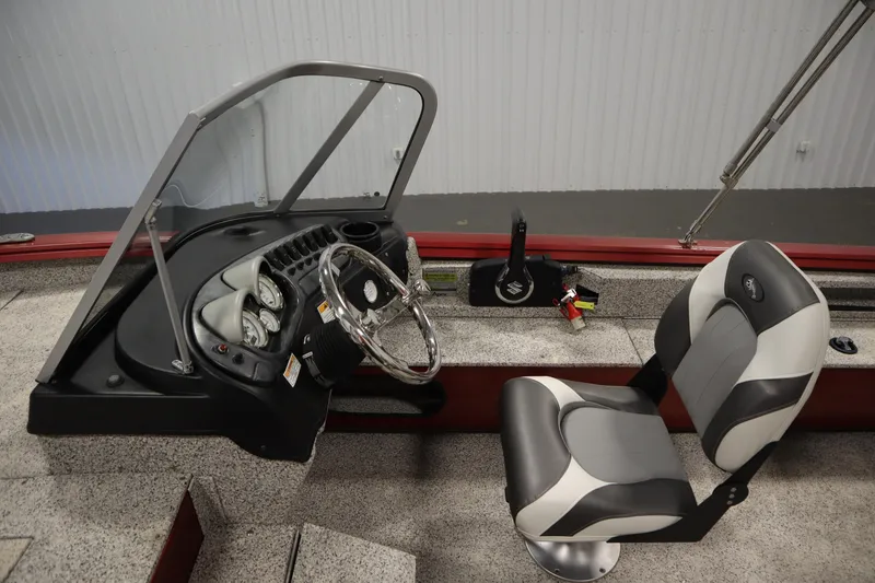 Slide: The Image of 2023 Polar Kraft Outlander DC boat interior with steering wheel and captain's chair. - 27