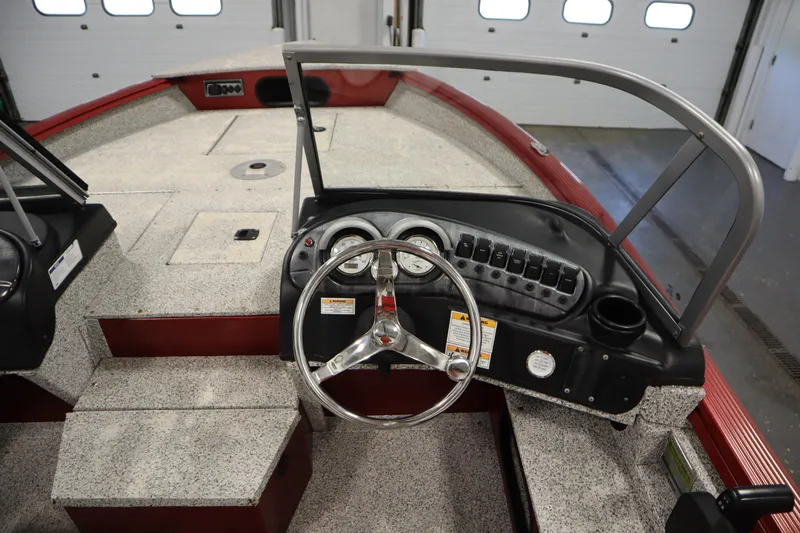 Slide: The Image of Steering console of a 2023 Polar Kraft 2010 OUTLANDER DC boat, featuring gauges and controls. - 28