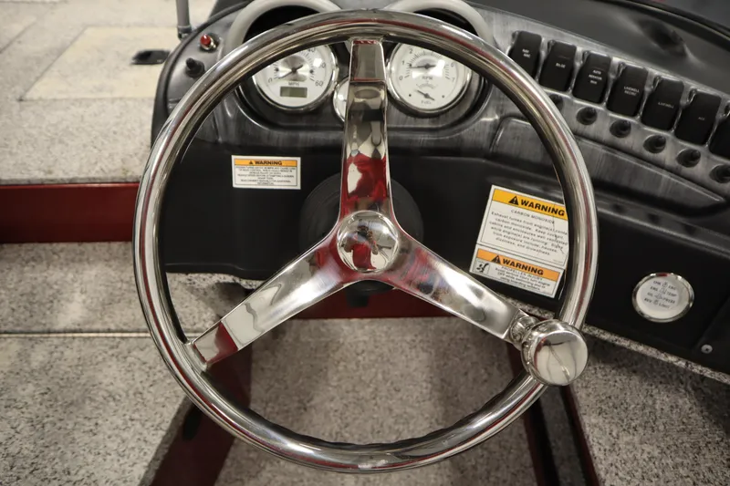 Slide: The Image of Steering wheel of 2023 Polar Kraft 2010 OUTLANDER DC boat, featuring gauges and warning labels. - 29