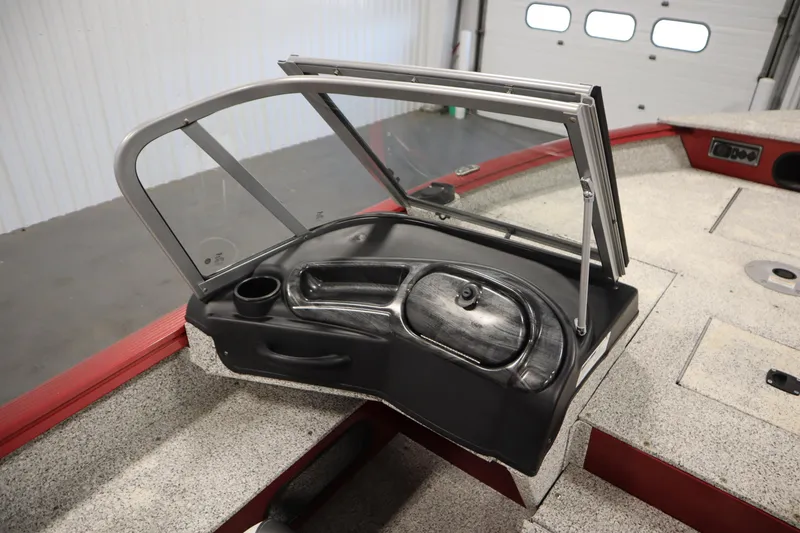 Slide: The Image of 2023 Polar Kraft 2010 OUTLANDER DC boat interior with open windshield and storage compartment. - 36