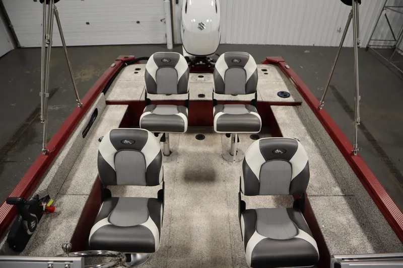Slide: The Image of 2023 Polar Kraft 2010 OUTLANDER DC boat interior with four seats and red accents. - 41