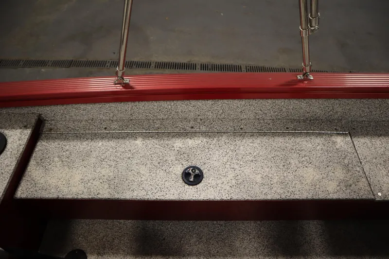 Slide: The Image of 2023 Polar Kraft Outlander DC boat interior with red trim and textured flooring. - 42